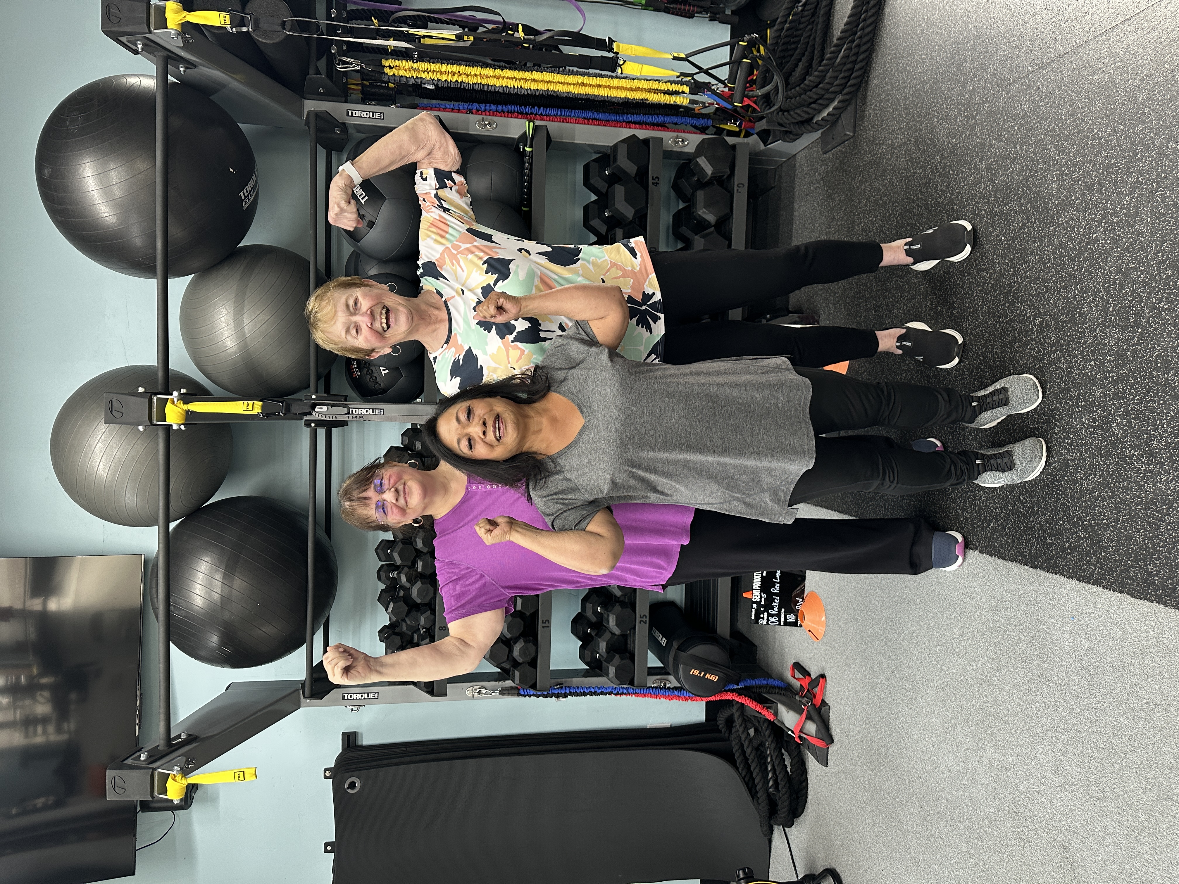 Trainer coaching a client through a strength training exercise