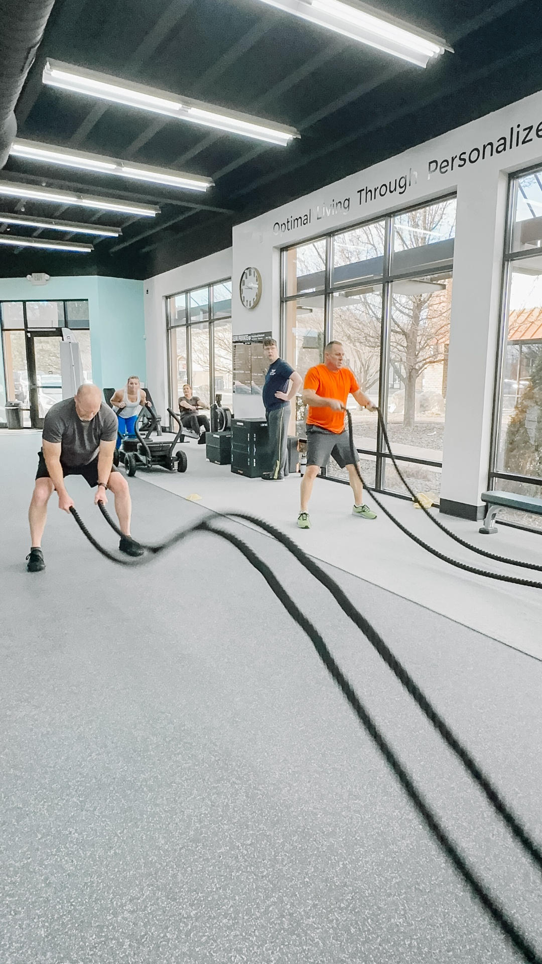 Athletes performing reactive agility and deceleration training in a well-lit gym