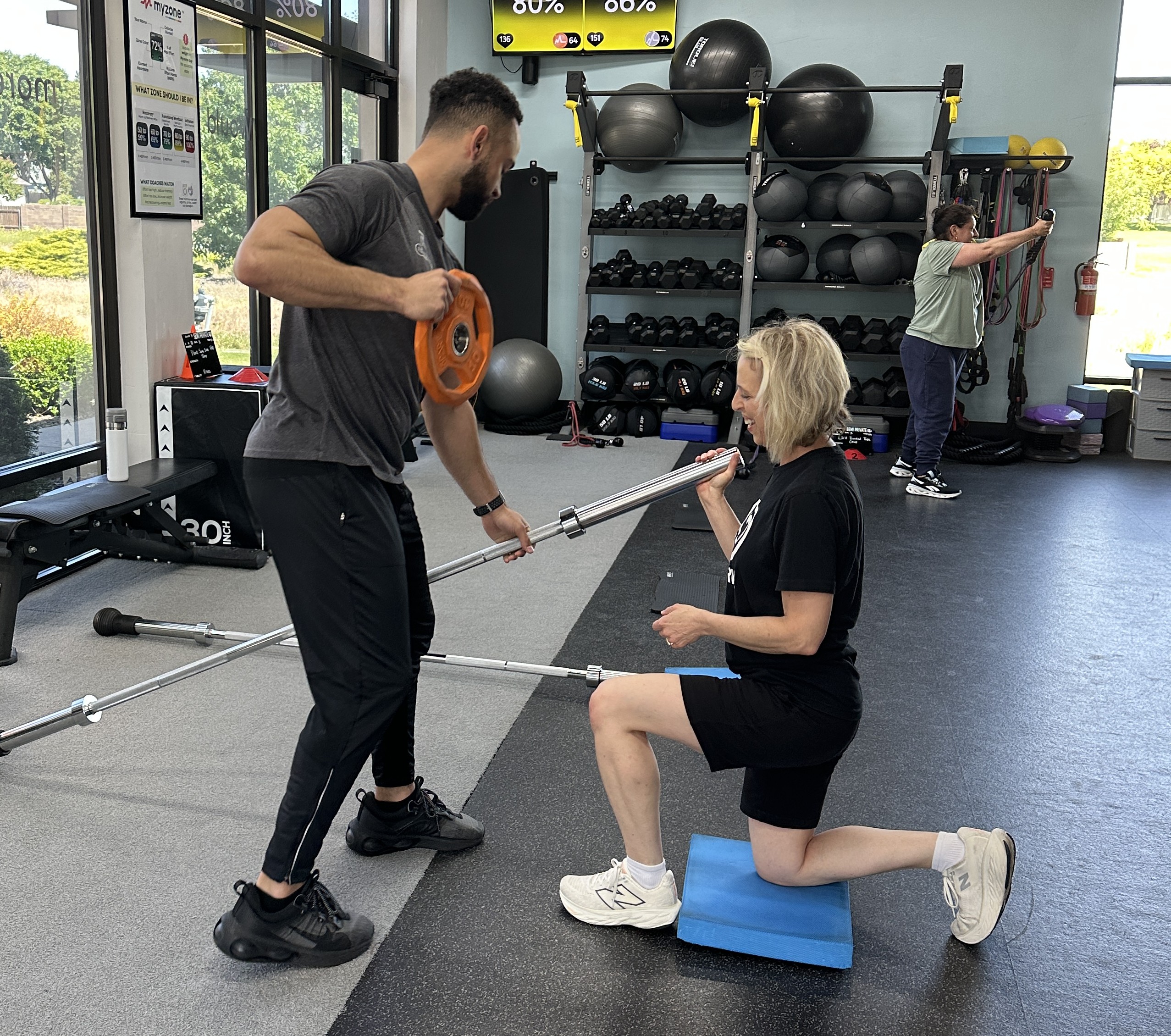Trainer coaching a woman during a strength training session